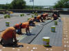 Inmates re-roof a state building in Pierre.